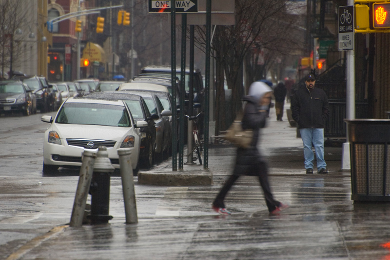 Slick sidewalks and streets on a rainy day.