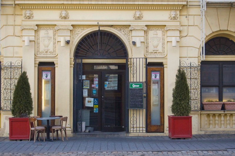 A restaurant with a baroque entrance.