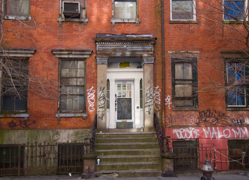 An old brick rowhouse, showing the wear of years.