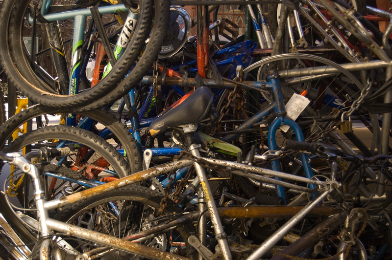 A mish mosh of bike frames, wheels, seats, and chains.
