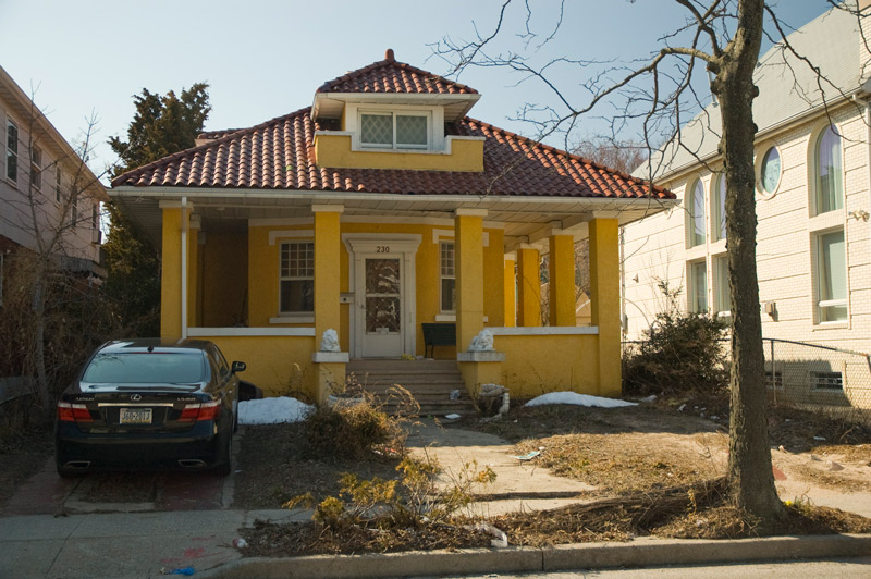 An old house with a tiled pyramid roof.