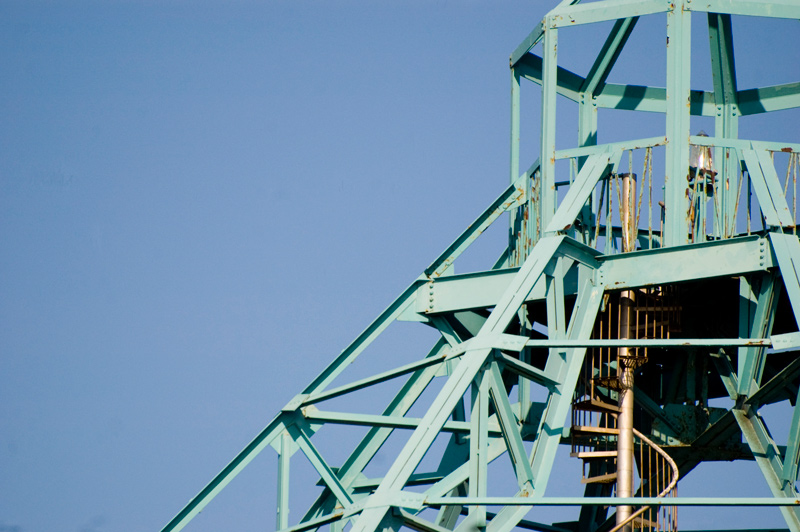 A spiral staircase leads to the top of a steel tower.