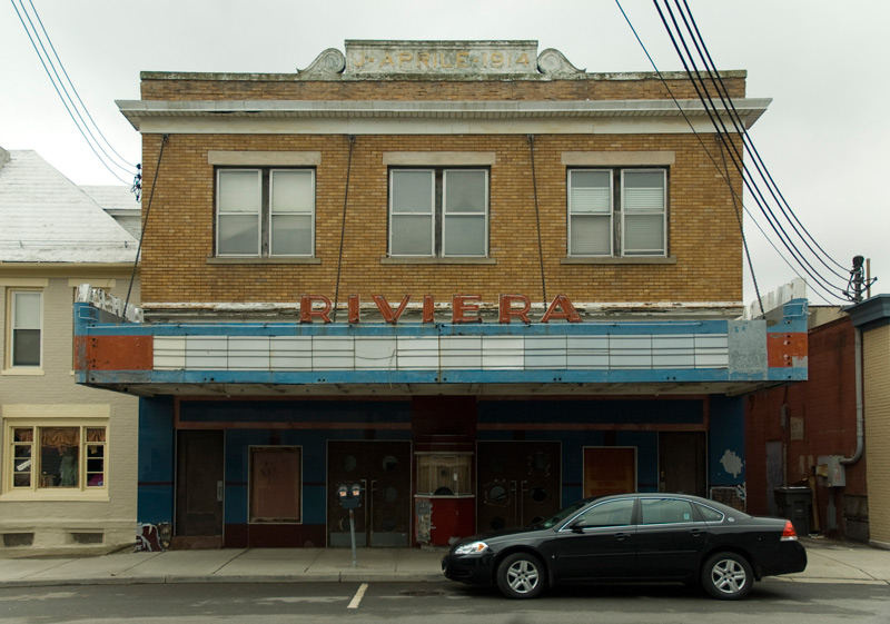 A theater, with a blank neon marquee.