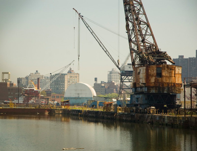 Rusted cranes in a docking area.