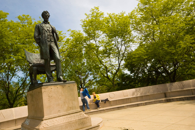 A statue of Abraham Lincoln in a plaza.