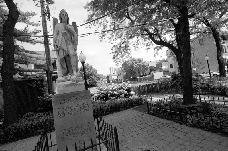 A statue showing St. Michael, with Satan underfoot.