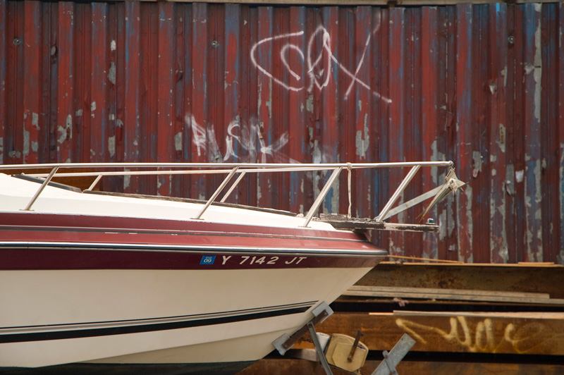 A boat's prow, in an industrial neighborhood.