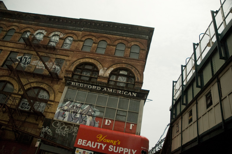 A building with an old sign reading 'Bedford American.'