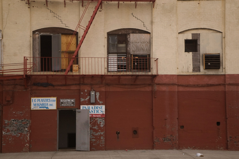 An open door on an industrial building, with floors above it.