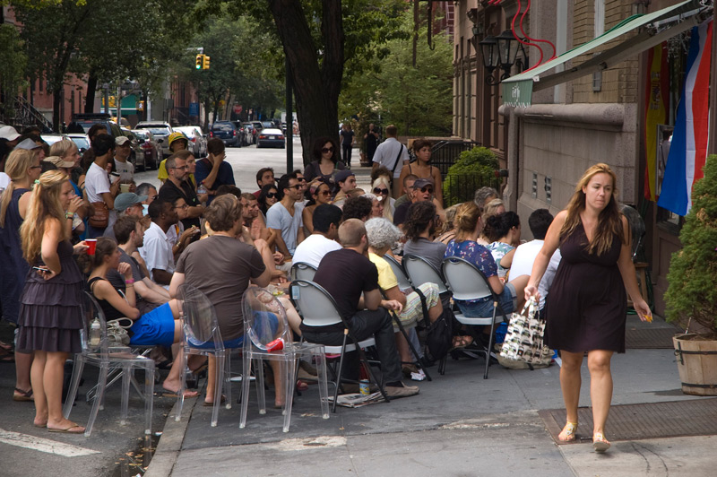 A woman walks past a crowd watching the World Cup final.