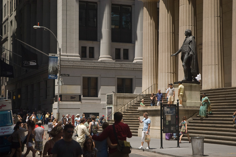 Tourists group for photos by a large statue of George Washington