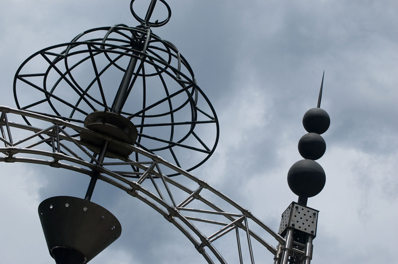 A metal archway of cones, spheres, and spikes