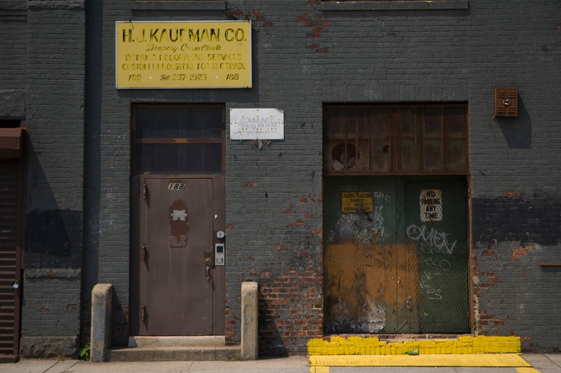 Old metal doors in a brick building, painted grey.