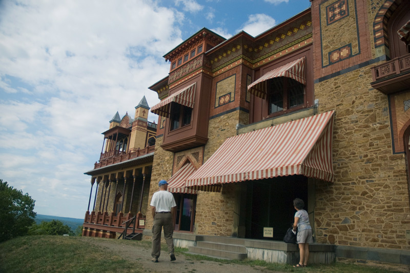 A pair of tourists outside a historic home built with Turkish influences.