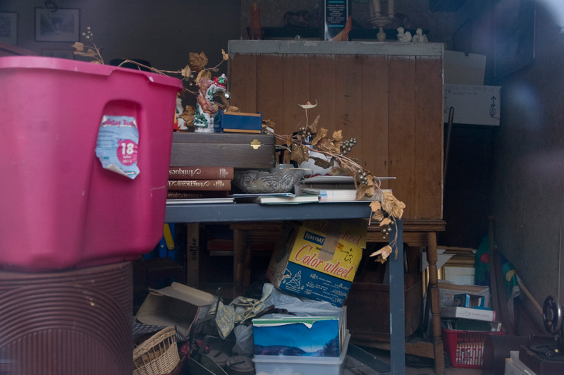 An old Christmas color wheel sits among other used goods in a shop.