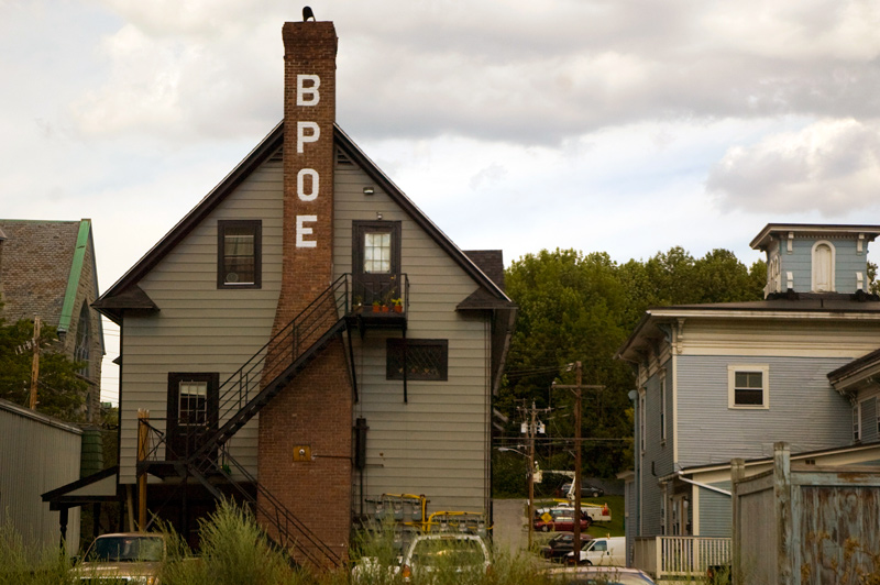 The Elks' acronym 'BPOE' in block letters on the chimney of a lodge.