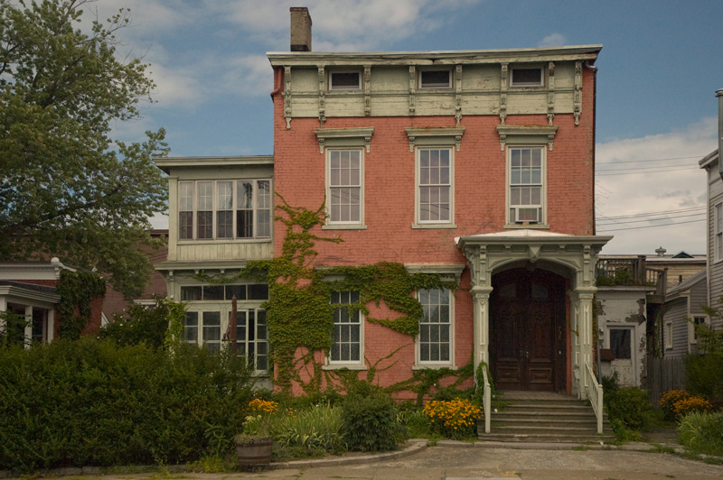 A two story btick house, sagging with age.