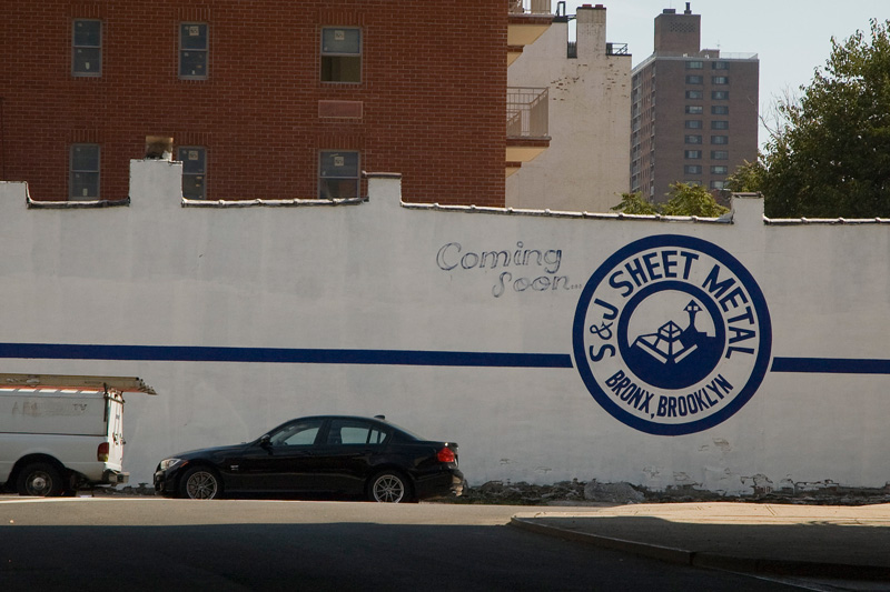 A wall sign promises a new sheet metal company is coming soon.