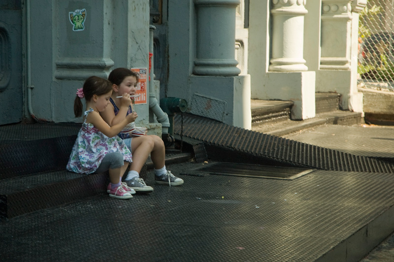 Two little kids eating ice cream.