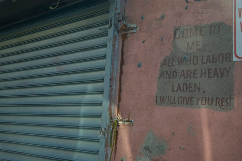 A passage from the Gospel of Matthew, painted on an old wall.