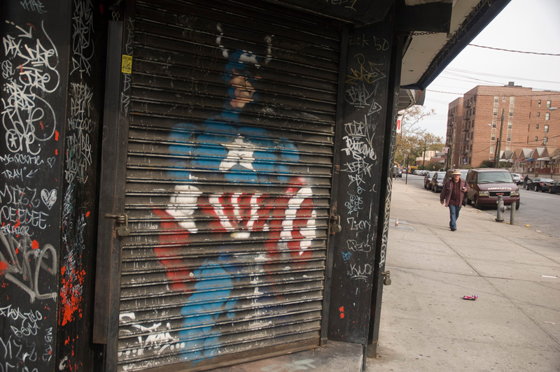 Captain America has been painted on the roll-down storefront's door.