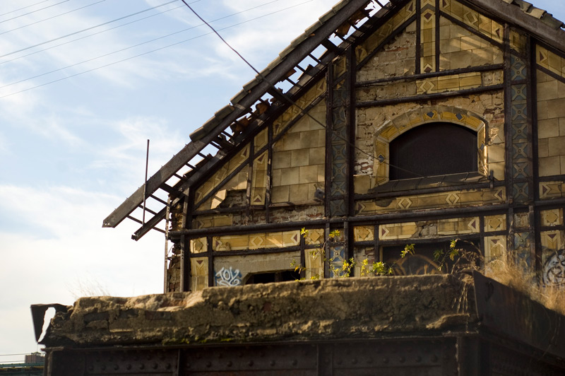 An abandoned train station, with some decorative tiles remaining.