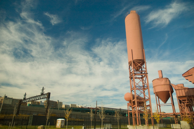 Remnants of a concrete plant, now painted red, decorate a park.