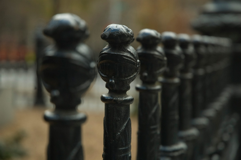 Metal fence posts, in the shape of sword handles.