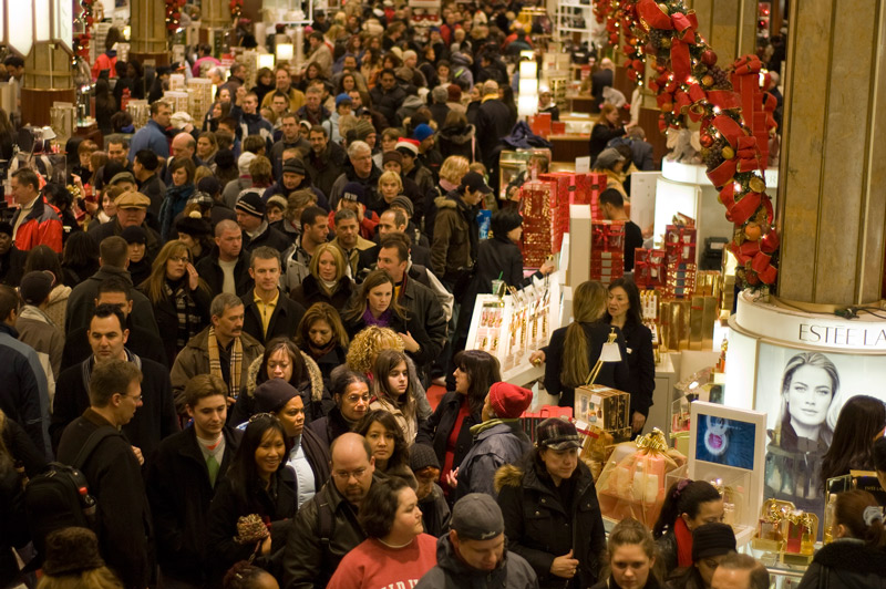 Crowds of shoppers in a department store.