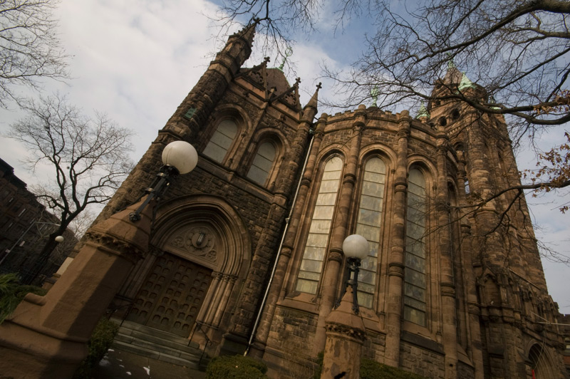 A church made of stone, with leafless trees.