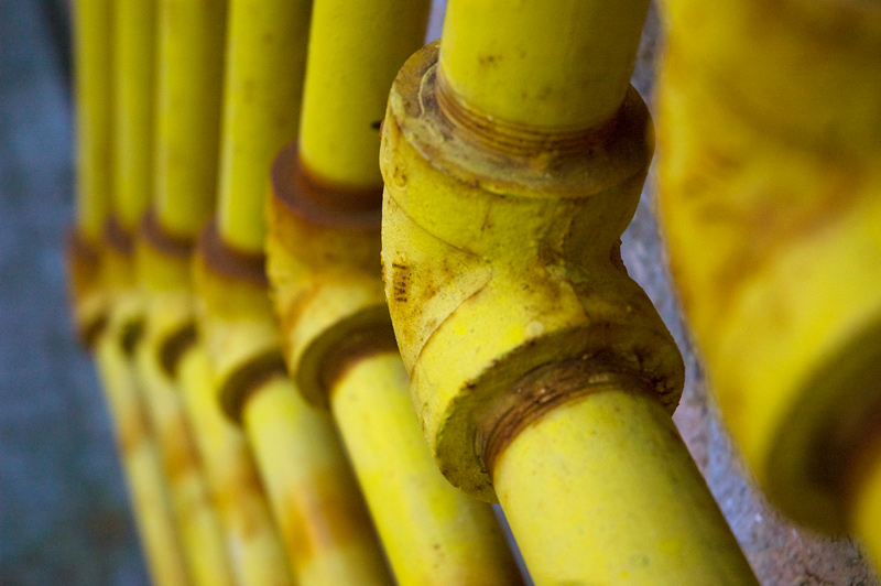 A series of yellow elbow pipes.
