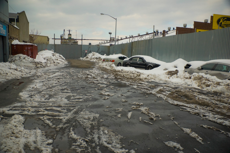 Melting snow and slush on an industrial street.