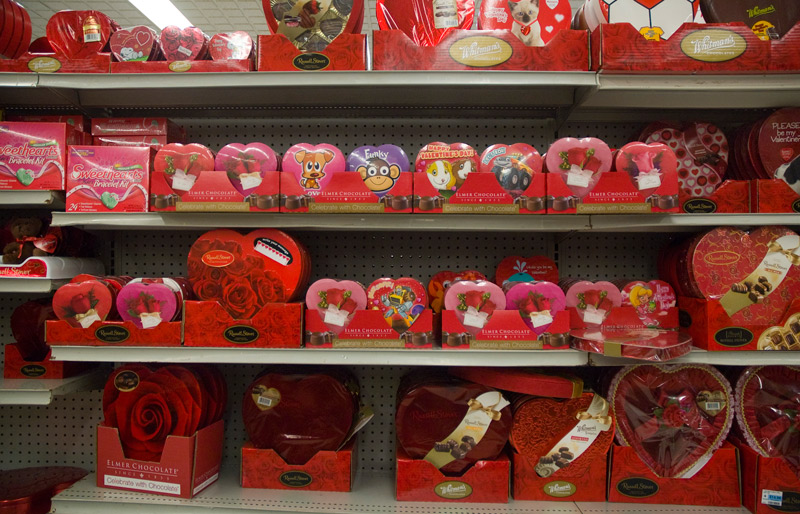 Bright red packages of candy for Valentine's Day, on a store's shelf.