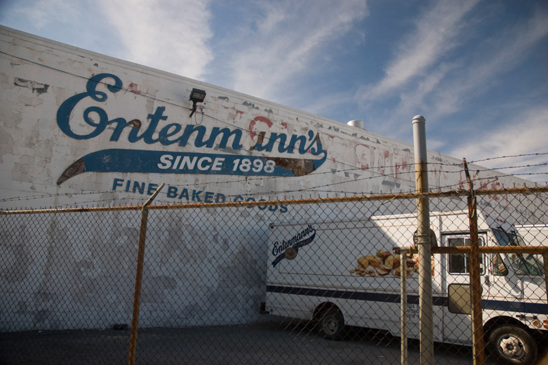 The Entemann's bakery in Brooklyn, with a worn sign and trucks.