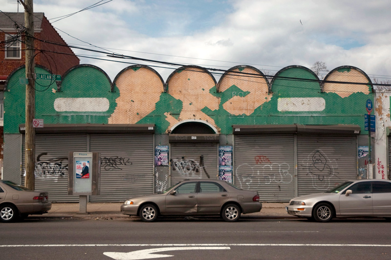 A vacant store with a decaying facade.