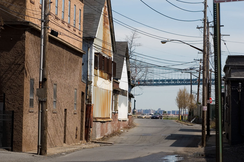 An empty street and the Verrazano Bridge.