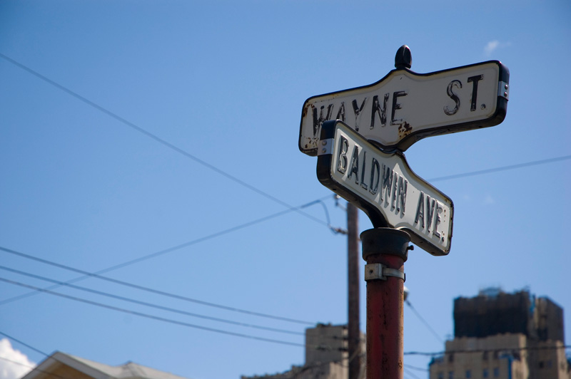 Street signs against a blue sky.