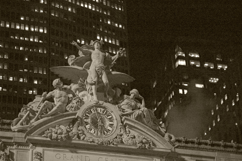 A statue of Mercury, on top of a clock.