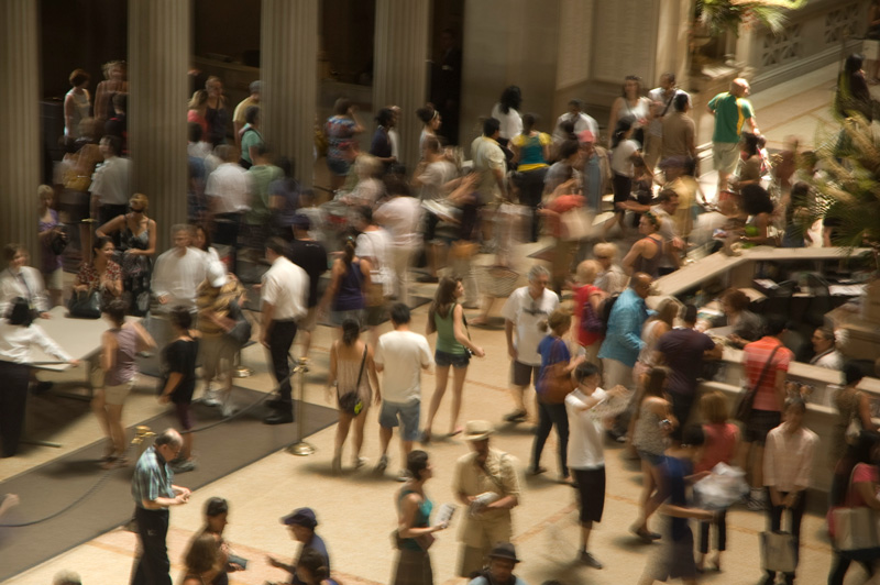 A crowded lobby with people milling about.