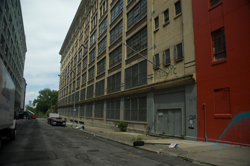 A graffiti tag reading 'Penelope' on an industrial street.