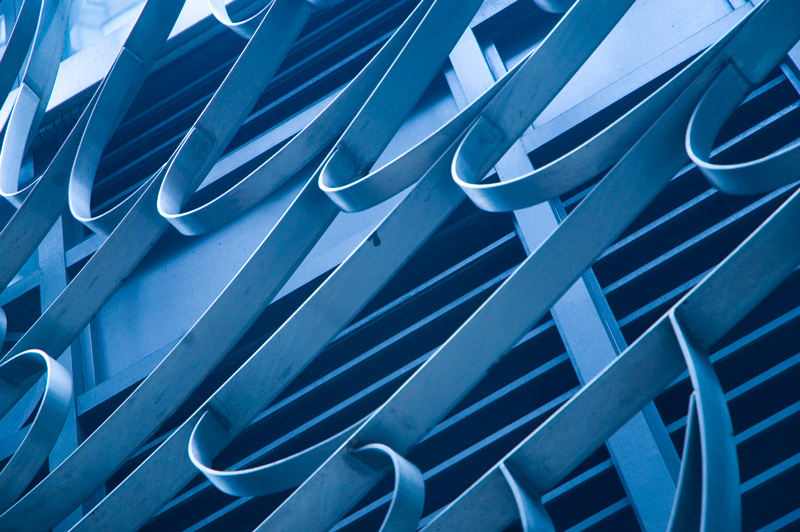 Curlicues of bent metal, in front of a grille.