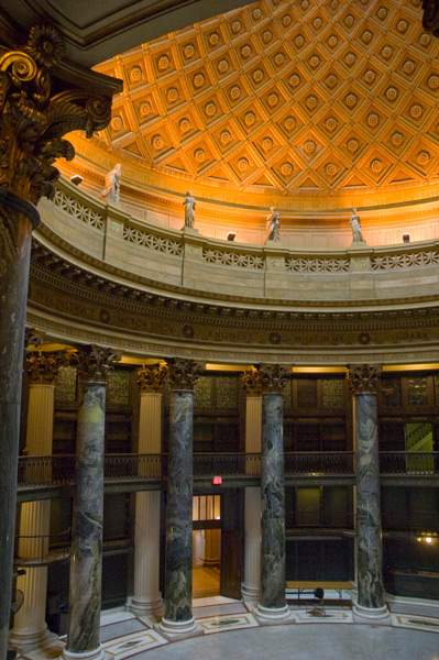 An ornate lobby with columns, statues, and a domed ceiling