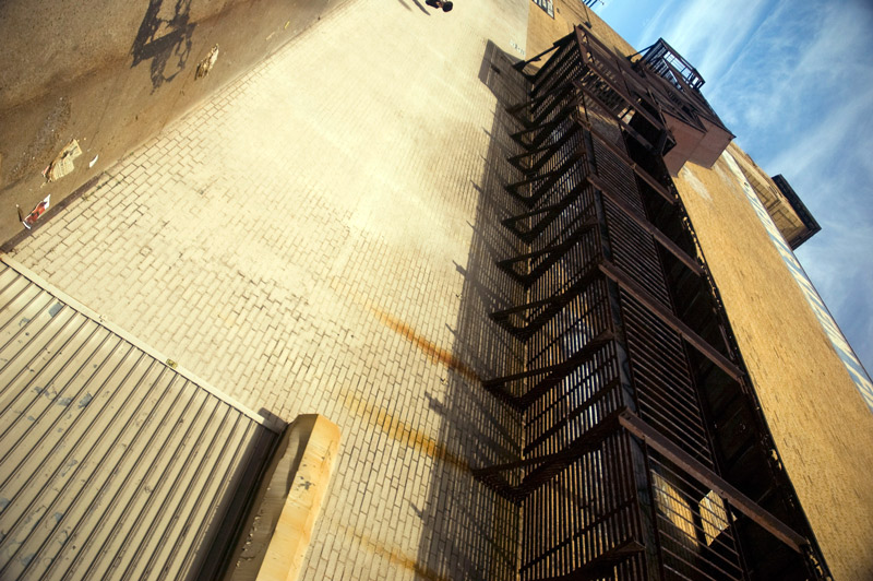 A long fire escape on the side of a brick building