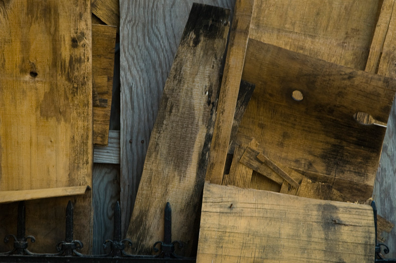 layers of warped grey and brown plywood in disarray