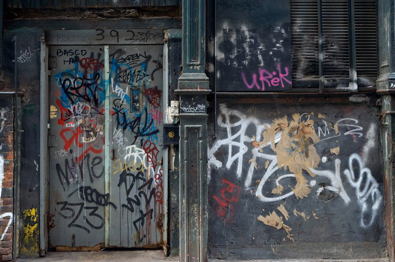 graffiti covers an entrance, walls...