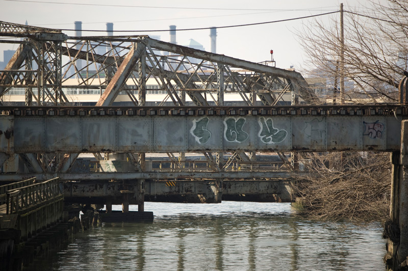 A trestle bridge, with graffiti on its side