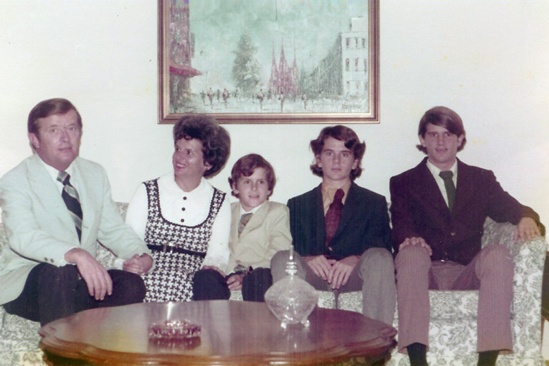 Living room shot of dad, mom, three kids