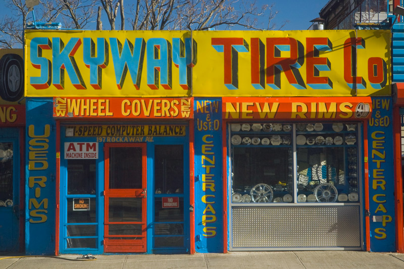 A brightly colored storefront for a tire and wheel company.