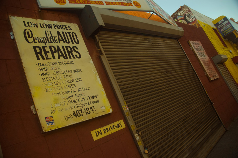 A hand-painted sign at an auto repair shop.