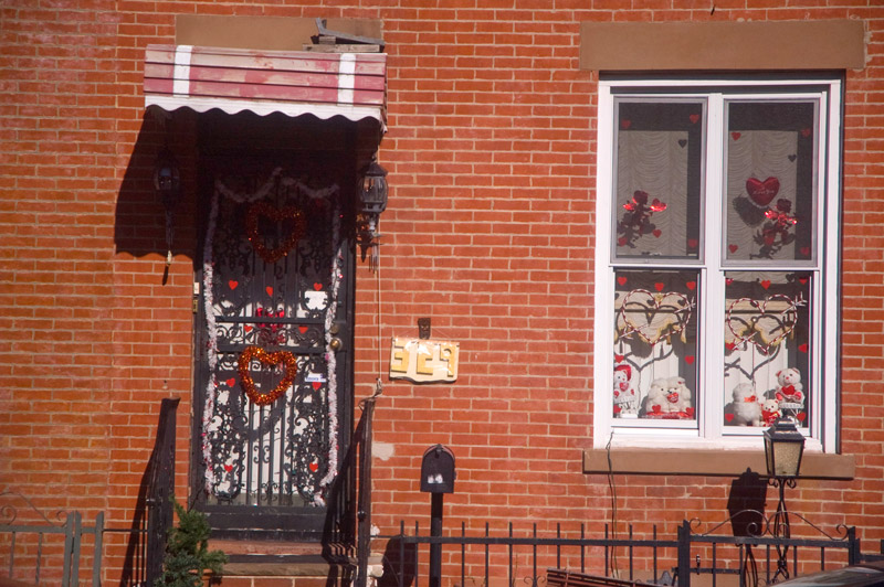 Valentines Day decorations on a home's door and windows.